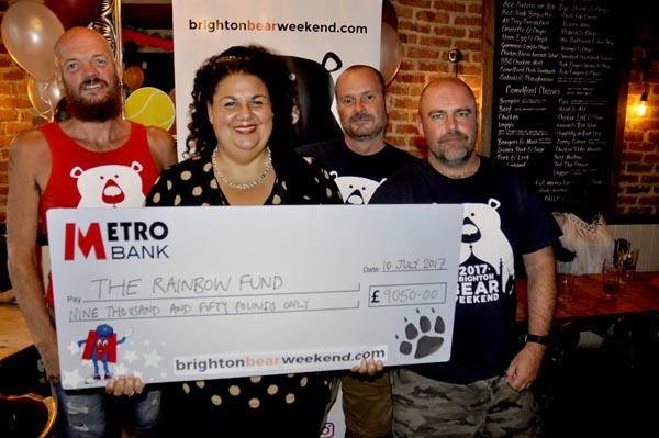 Maria Baker from Rainbow Fund grants committee accepts cheque for £9.050 from Brighton Bear Weekend committee