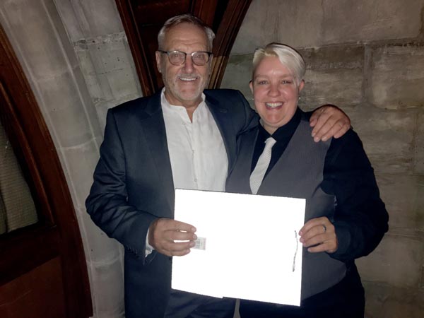 Claire Fuller receives certificate from Rainbow Fund Chair, Chris Gull for raising £300